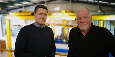 Senior leaders stood in front of shop floor at DT Engineering