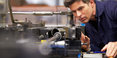 Close Up Of Factory Engineer Operating Hydraulic Tube Bender