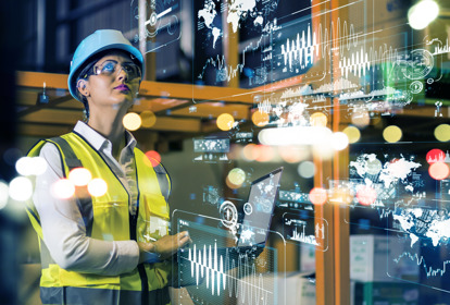 Female manufacturer in factory looking at information on heads up display