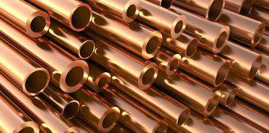 Close up of a stack of copper pipes