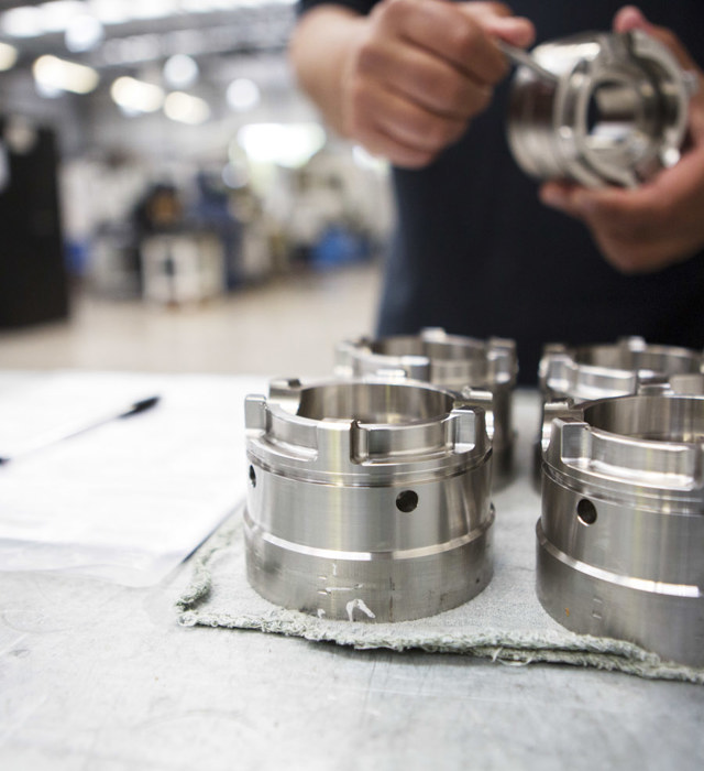 Engineer inspecting machined parts at Beverston Engineering