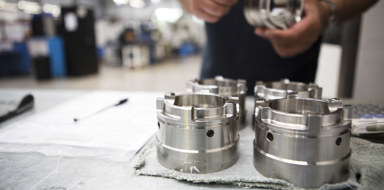 Engineer inspecting machined parts at Beverston Engineering