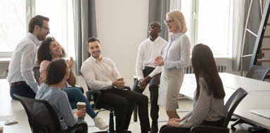 Diverse corporate team having coffee break in coworking space