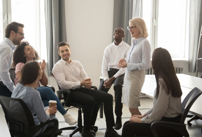 Diverse corporate team having coffee break in coworking space