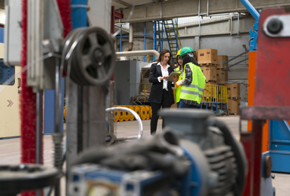 Female supervisor in the factory holding the tablet