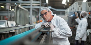 Factory engineer monitoring production line in drinks production plant