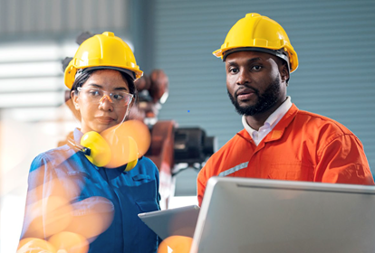 UK manufacturing diversity & inclusion guide - A man and a woman with construction hats working on a manufacturing facility.
