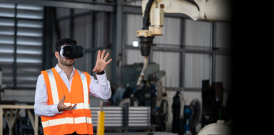 Man operating a robotic arm using Virtual Reality technology
