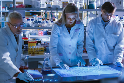 Diverse International Team of Scientists are Working on a Digital Touch Screen in High Tech Research Laboratory. Professionals Teamwork.