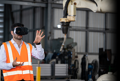 Man operating a robotic arm using Virtual Reality technology