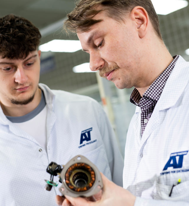 Close up of members of staff discussing finished parts at ATEC Solutions