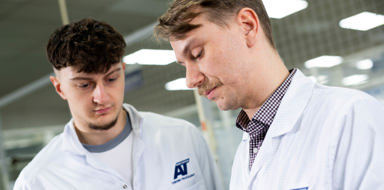 Close up of members of staff discussing finished parts at ATEC Solutions