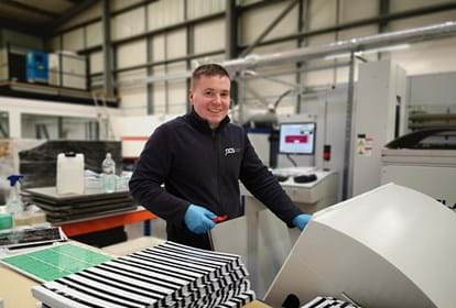 Manufacturer smiling at the camera from Plastic Card Services
