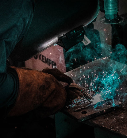 Person welding machine parts