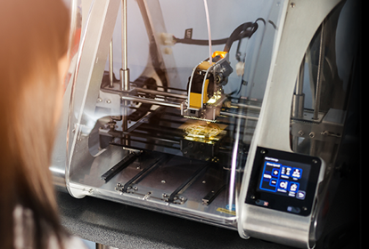 Female engineer operating a 3D printer